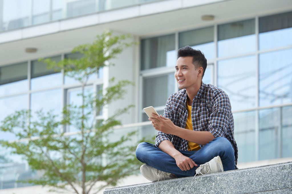 Man on his mobile device banner